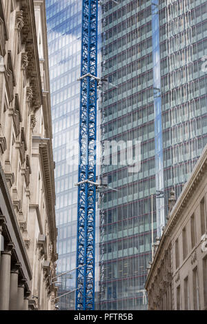 Old architecture and the new development high-rise development at 22 Bishopsgate in the City of London - the capital's financial district, on 21st August 2018, in London, England. 22 Bishopsgate is a commercial skyscraper under construction in London, United Kingdom. It will occupy a prominent site on Bishopsgate, in the City of London financial district, and is set to stand 278 m tall with 62 storeys. The project replaces an earlier plan for a 288 m tower named The Pinnacle, on which construction was started in 2008 but suspended in 2012 following the Great Recession, Stock Photo