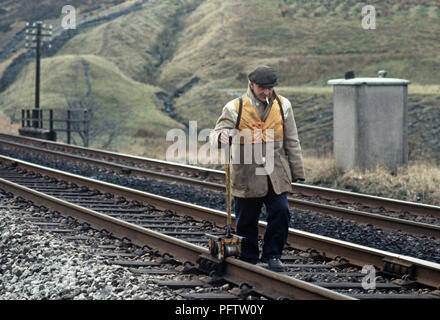 British Rail line workers wearing orange safety jackets on the Settle