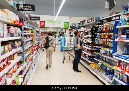 People shopping in Asda supermarket aisle, Asda, Bury St Edmunds, Suffolk UK Stock Photo