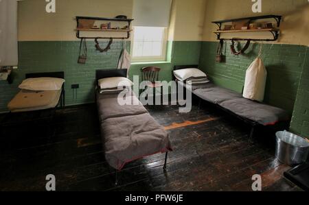 Beds and kit belonging to WW1 soldiers in a restored army barracks room Stock Photo