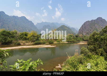 Beautiful view of the Nam Song River and karst limestone mountains near Vang Vieng, Vientiane Province, Laos, on a sunny day. Stock Photo