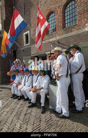 Alkmaar, Netherlands - July 20, 2018: Group of cheese carriers in front of the Waag building before the starts of the cheese market Stock Photo