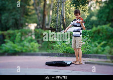 Kyiv - Ukraine, 11.08.2018: Street musician playing violin in park. Stock Photo