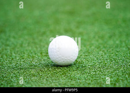 White dimple hockey ball on astro turf Stock Photo