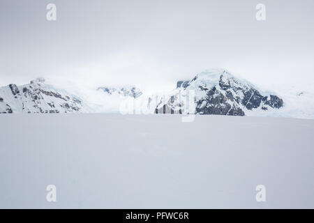 icecaps in the Antarctica with iceberg in the ocean swimming around and melting in the sea Stock Photo