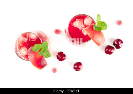 Overhead photo of vibrant red drinks with berries and sweets on white Stock Photo