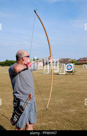 male archer using a bow for target practice at an archery club Stock Photo