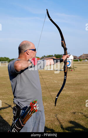 male archer using a bow for target practice at an archery club Stock Photo