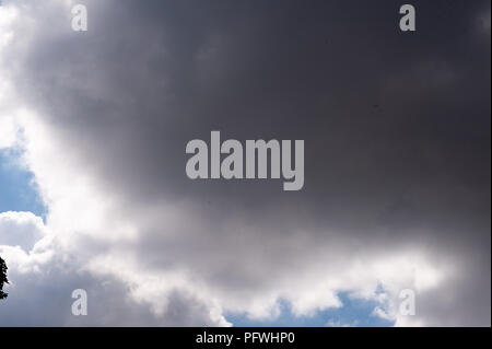 timelapse of moving clouds going from a bright sky to a dark sky Stock Photo