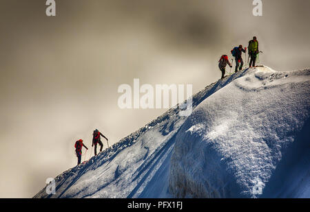 Climbers on the arete leading up from the Vallee Blanche to the Aiguille Du Midi above Chamonix, France. Stock Photo