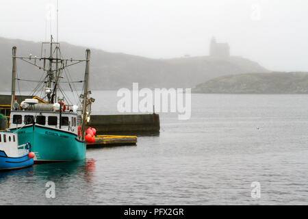 Boat dock in Rose Blanche Harbour and Diamond Cove, Newfoundland, Canada.  Rose Blanche Lighthouse in the background Stock Photo