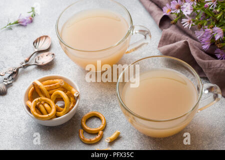 Cup of coffee with milk and crackers on the gray table. concept Breakfast Home cozy. Stock Photo