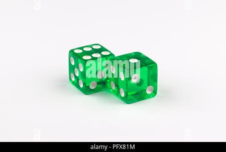 A pair of green, translucent gaming dice on a white background, with the white spots showing a several combinations that add up to lucky number seven  Stock Photo