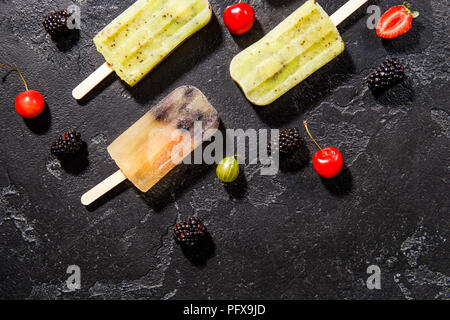 Photo on top of frozen fruit ice on sticks and berries Stock Photo