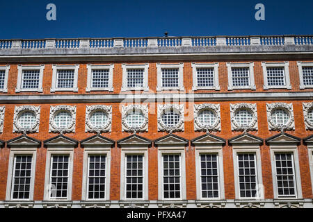 Hampton Court Palace, Richmond, London, UK - 22 April 2018 - The South Front of Hampton Court,designed by Christopher Wren, viewed from Fountain court