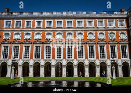 Hampton Court Palace, Richmond, London, UK - 22 April 2018 - The South Front of Hampton Court,designed by Christopher Wren, viewed from Fountain court