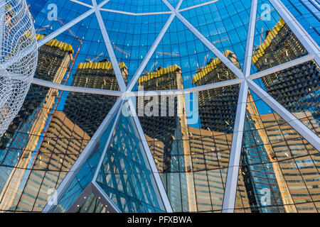 New Telus Sky building construction reflected in Bow Tower glass, Downtown, Calgary, Alberta, Canada. Stock Photo