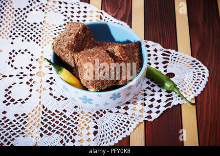 Whole grain corn bread in bowl on dinner table Stock Photo