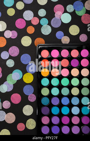 Makeup background made of eyeshadow palette with confetti Stock Photo