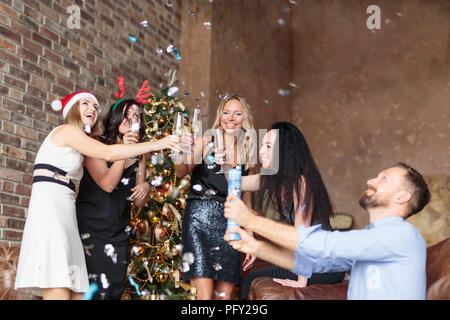 Happy people toasting with champagne while having fun on Christmas party Stock Photo