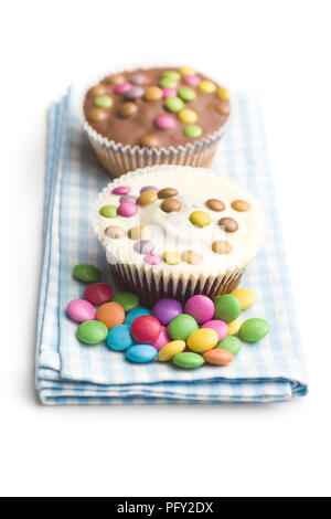 Sweet cupcakes with candies isolated on white background. Stock Photo