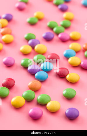 Multi colorful candies on pink background. Stock Photo