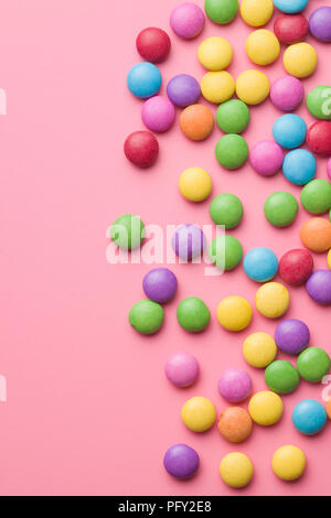 Multi colorful candies on pink background. Stock Photo