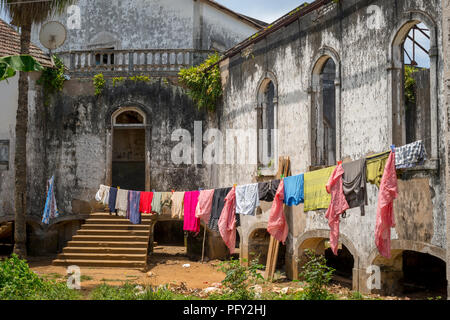 Laundry hangs to dry in front of the former Hospital of 1928, Roça Água Ize, São Tomé Island, São Tomé and Príncipe Stock Photo