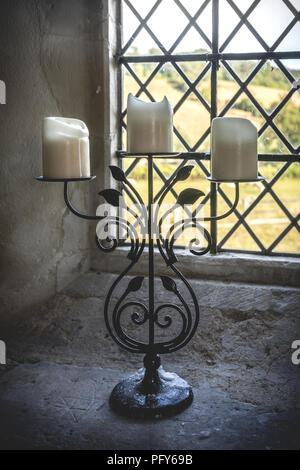 Church candle holder in front of a window, England, UK Stock Photo