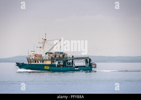 Darwin, Northen Territory, Australia - December 1, 2009: Closeup of Green Kalinds fishing vessel sailing the Timor Sea. One person on deck. Sloops on  Stock Photo
