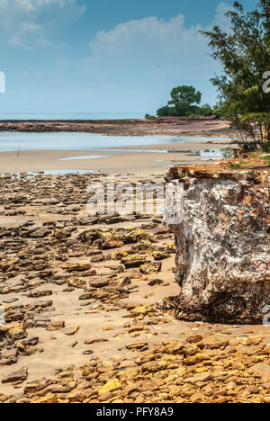 Darwin, Northen Territory, Australia - December 1, 2009: Landscape of shore line of Timor Sea shows rocky sandy beach with line of green vegetation di Stock Photo