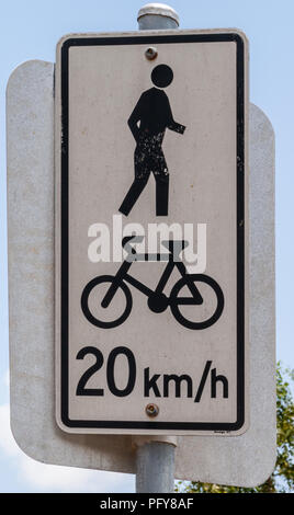 Darwin, Northen Territory, Australia - December 1, 2009: Closeup of maximum bike speed sign is white with black characters against ligh blue sky. Warn Stock Photo