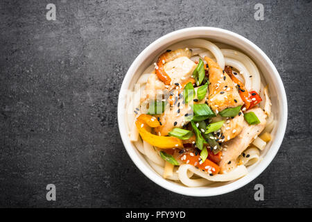 Udon stir-fry noodles with chicken and vegetables. Stock Photo