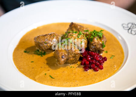 Swedish meatballs in a sauce with lingonberry sauce on a plate Stock Photo