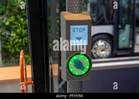 Illuminated city bus stop button close up. Stock Photo