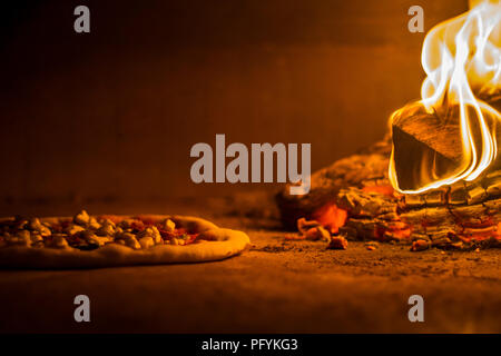 Pizza in the wood burning fire oven Stock Photo