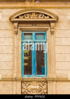 View of the window with a bas-relief on the facade of the building, Punta Arena, Chile. Vertical Stock Photo