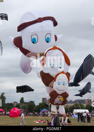 three Kites in the shape of bears flying against a cloudy sky Stock Photo