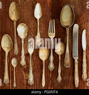 Vintage cutlery on rustic wooden background in flat lay Stock Photo