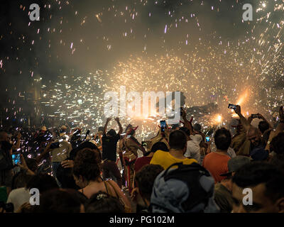 Barcelona, Spain. August 22, 2018 - People dancing in the Fire Run 'Correfoc' celebration in Gracia Festival in Barcelona Stock Photo