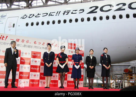 Tokyo, Japan. 23rd Aug, 2018. Japan Airlines (JAL) president Yuji Akasaka (L) smiles with cabin attendants in uniforms of (2nd L-R) third, fifth, sixth, eighth and current generations as he announces the business strategy for 2020 at a JAL hangar of the Haneda airport in Tokyo on Thursday, August 23, 2018. JAL will invest 10 billion yen to improve airport facilities and will change their uniforms in 2020. Credit: Yoshio Tsunoda/AFLO/Alamy Live News Stock Photo