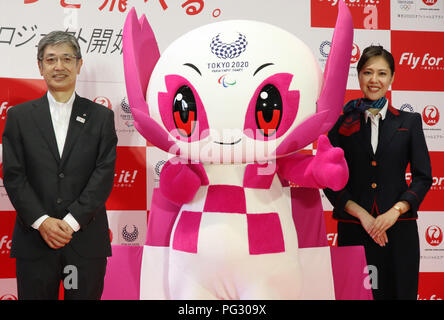 Tokyo, Japan. 23rd Aug, 2018. Japan Airlines (JAL) president Yuji Akasaka (L) smiles with Tokyo 2020 paralympics mascot Someity (C) and a cabin attendant as he announces the business strategy for 2020 at a JAL hangar of the Haneda airport in Tokyo on Thursday, August 23, 2018. JAL will invest 10 billion yen to improve airport facilities and will change their uniforms in 2020. Credit: Yoshio Tsunoda/AFLO/Alamy Live News Stock Photo