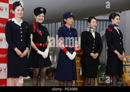 Tokyo, Japan. 23rd Aug, 2018. Japan Airlines (JAL) cabin attendants in uniforms of (L-R) third, fifth, sixth, eighth and current generations smile as JAL president Yuji Akasaka announce sthe business strategy for 2020 at a JAL hangar of the Haneda airport in Tokyo on Thursday, August 23, 2018. JAL will invest 10 billion yen to improve airport facilities and will change their uniforms in 2020. Credit: Yoshio Tsunoda/AFLO/Alamy Live News Stock Photo