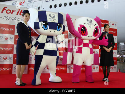 Tokyo, Japan. 23rd Aug, 2018. Tokyo 2020 Olympics mascot Miraitowa (2nd L) and Paralympics mascot Someity (2nd R) smile with Japan Airlines (JAL) cabin attendants in uniforms of third (L) and current generations as JAL president Yuji Akasaka announce sthe business strategy for 2020 at a JAL hangar of the Haneda airport in Tokyo on Thursday, August 23, 2018. JAL will invest 10 billion yen to improve airport facilities and will change their uniforms in 2020. Credit: Yoshio Tsunoda/AFLO/Alamy Live News Stock Photo