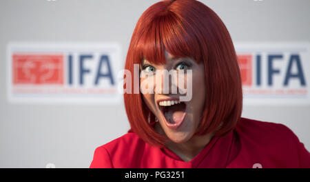 Berlin, Germany. 23rd Aug, 2018. Miss IFA is about to hold the IFA kick-off press conference for the photographers Model. The Consumer Electronics Fair will take place from August 31 to September 5 at the Berlin Exhibition Grounds. Credit: Ralf Hirschberger/dpa/Alamy Live News Stock Photo