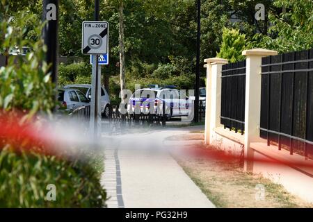 Paris, France. 23rd Aug, 2018. Policemen block the road near the scene of an attack, in Paris suburbs, France, on Aug. 23, 2018. One person was killed and two others wounded in a knife attack on Thursday in Paris suburbs, local media cited police as saying. Credit: Chen Yichen/Xinhua/Alamy Live News Stock Photo