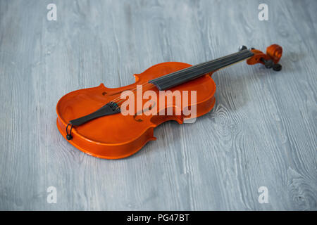 violin toy on a background of gray wooden boards Stock Photo