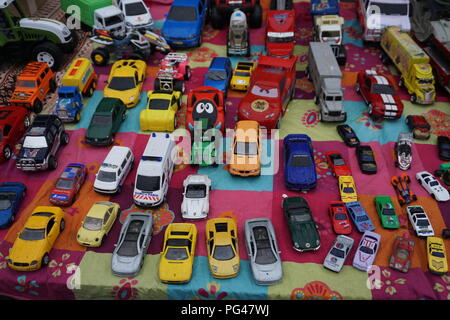 Colorful vintage car toys for sale at the outdoor market in the street in