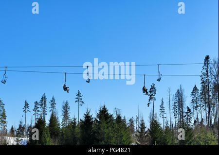 ski lift chairs on bright winter day Stock Photo