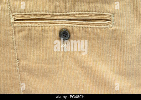 Textile Fabric of Corduroy Pants as Background. Pocket in Pants Closeup. Texture of Beige Velvet Clothes. Stock Photo